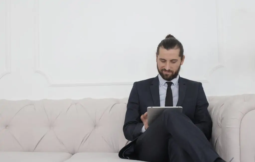 pexels-photo-3756918 Beard Man in Black Suit Sitting on White Couch